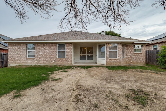 3804 Periwinkle Dr, Fort Worth, TX 76137 - back of house with fence, a shingled roof, a chimney, and brick siding