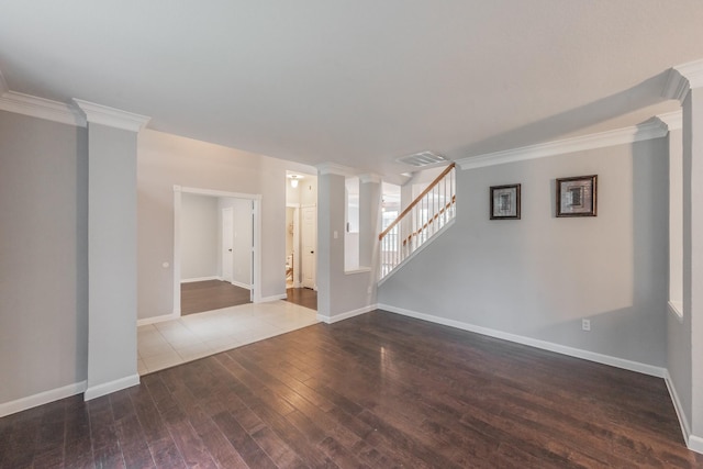 unfurnished living room featuring dark wood-style flooring, decorative columns, ornamental molding, and visible vents