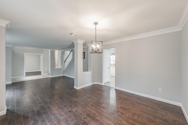 empty room with visible vents, dark wood-style floors, and ornamental molding