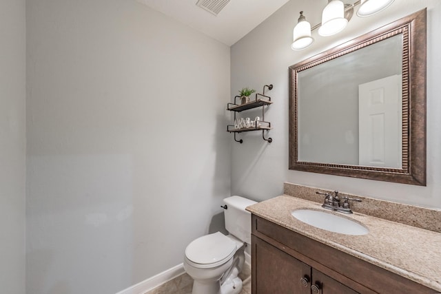 bathroom featuring visible vents, baseboards, toilet, and vanity