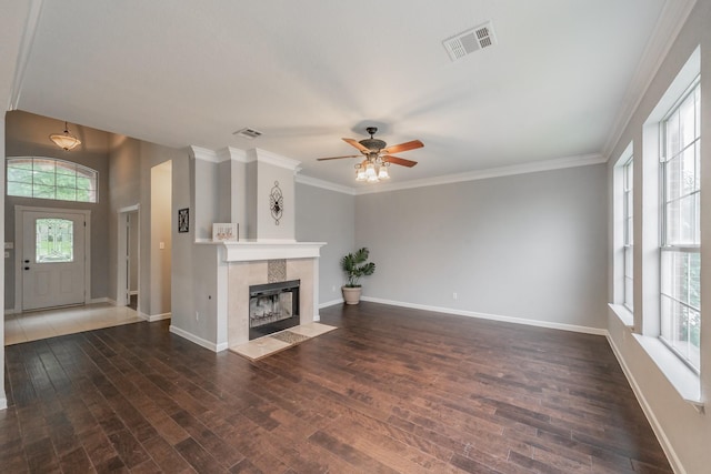 unfurnished living room featuring baseboards, ceiling fan, wood finished floors, and visible vents