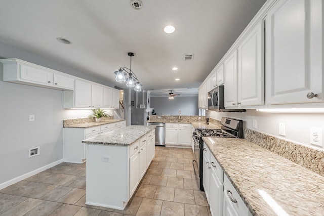 kitchen with a ceiling fan, appliances with stainless steel finishes, white cabinets, and light stone countertops