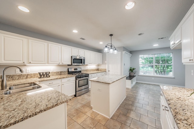 kitchen with white cabinetry, appliances with stainless steel finishes, a sink, and visible vents