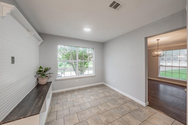 interior space with baseboards, visible vents, and an inviting chandelier