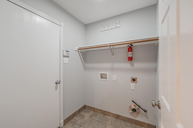 washroom with laundry area, electric dryer hookup, baseboards, hookup for a washing machine, and light tile patterned flooring