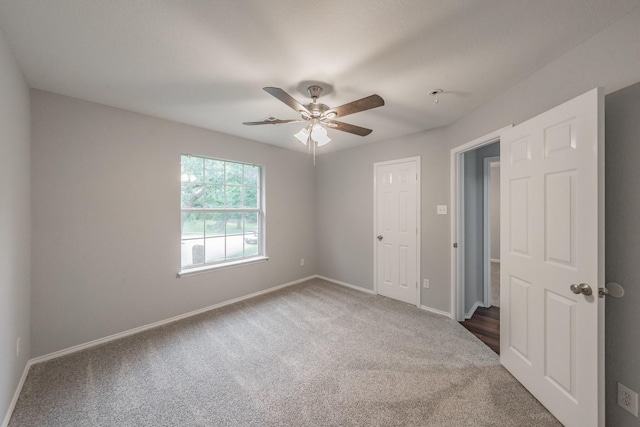 unfurnished bedroom featuring baseboards, ceiling fan, and carpet