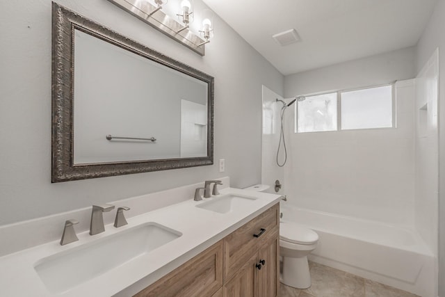 full bath with a sink, bathtub / shower combination, toilet, and double vanity