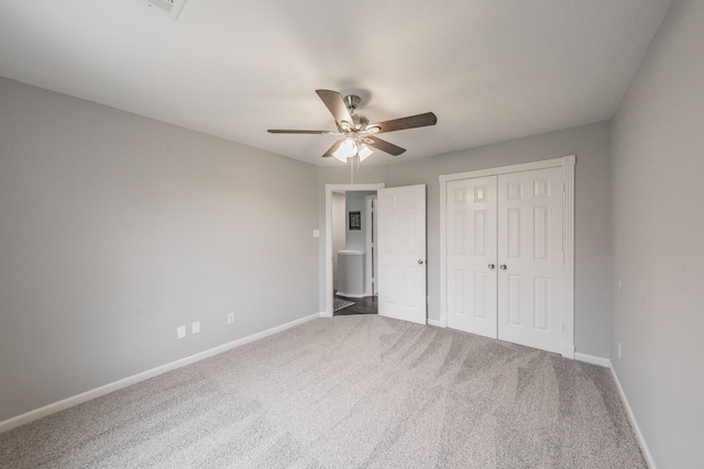 unfurnished bedroom featuring carpet floors, baseboards, and a closet