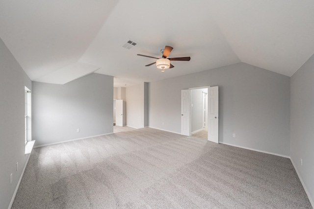 interior space with visible vents, ceiling fan, vaulted ceiling, and carpet floors