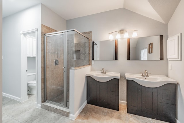 full bathroom with a sink, a stall shower, toilet, and two vanities