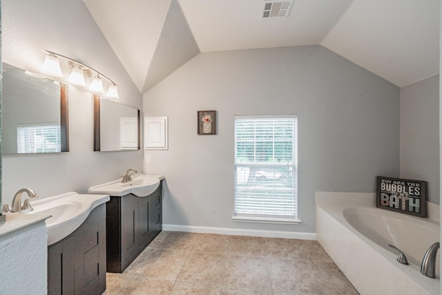 bathroom featuring visible vents, two vanities, a sink, and lofted ceiling