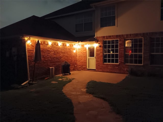 exterior space with a patio area and brick siding