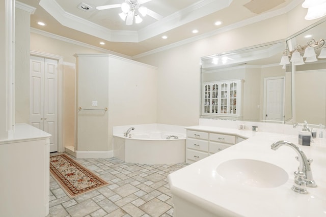 bathroom with a raised ceiling, a ceiling fan, ornamental molding, a garden tub, and a closet