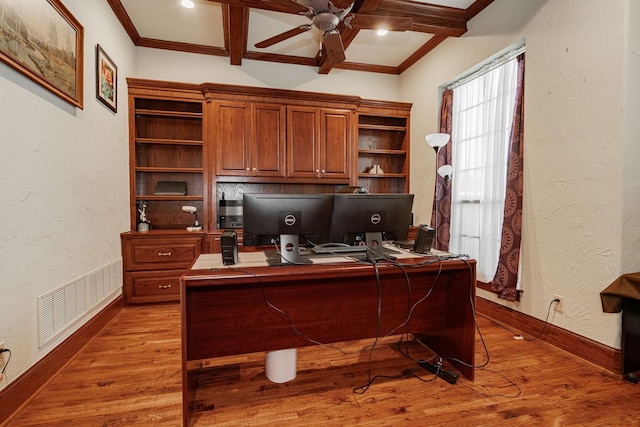 home office with visible vents, a ceiling fan, crown molding, and wood finished floors