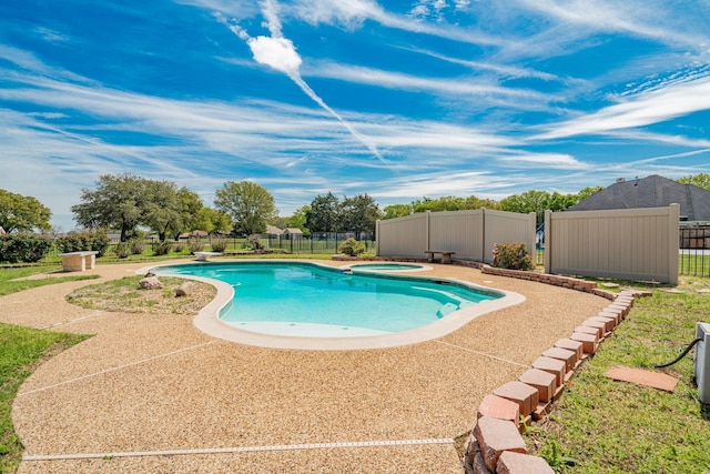 view of swimming pool with an in ground hot tub, fence, and a fenced in pool