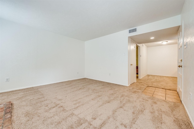 carpeted empty room with baseboards