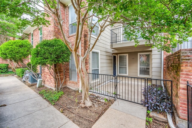 7510 Holly Hill Dr Unit 159, Dallas, TX 75231 - entrance to property featuring a balcony and brick siding