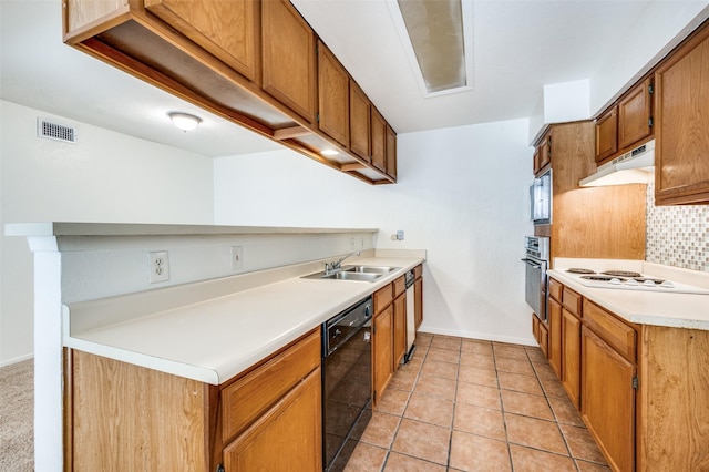 7510 Holly Hill Dr Unit 159, Dallas, TX 75231 - kitchen featuring appliances with stainless steel finishes, a sink, under cabinet range hood, backsplash, and light countertops