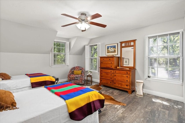 bedroom featuring a ceiling fan, baseboards, wood finished floors, and lofted ceiling