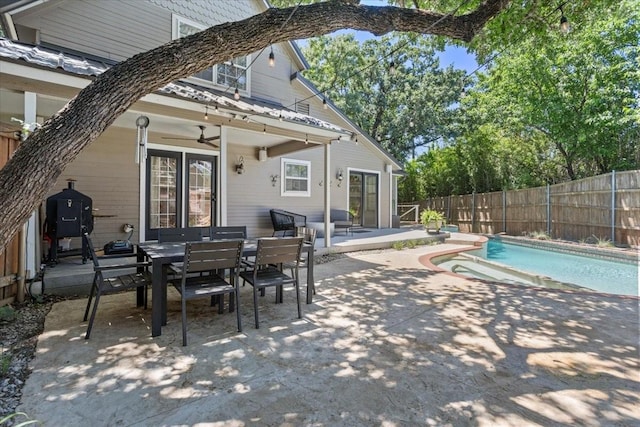 exterior space with a fenced backyard, outdoor dining area, a fenced in pool, and ceiling fan