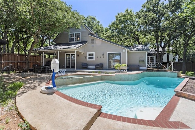view of swimming pool featuring a patio, a jacuzzi, and a fenced in pool