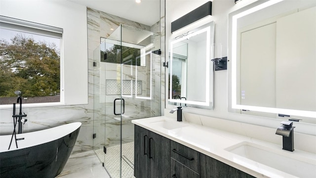 2316 Arroyo Ave, Dallas, TX 75219 - bathroom featuring marble tiled flooring, a marble finish shower, a freestanding bath, double vanity, and tile walls