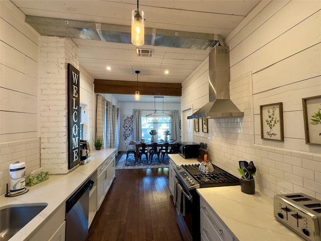 kitchen featuring wall chimney range hood, light stone countertops, dark wood-type flooring, visible vents, and black appliances