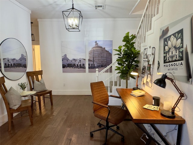 office featuring baseboards, a notable chandelier, wood finished floors, and visible vents