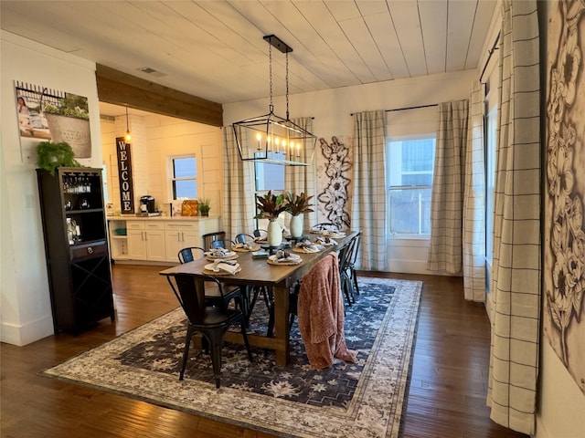 dining area with an inviting chandelier, wood ceiling, dark wood-style flooring, and visible vents