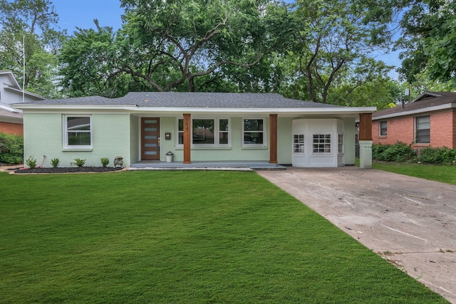 ranch-style home with covered porch, driveway, and a front yard