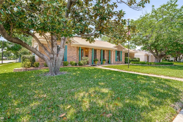 3150 Palmdale Cir, Farmers Branch, TX 75234 - view of front of house with brick siding and a front yard