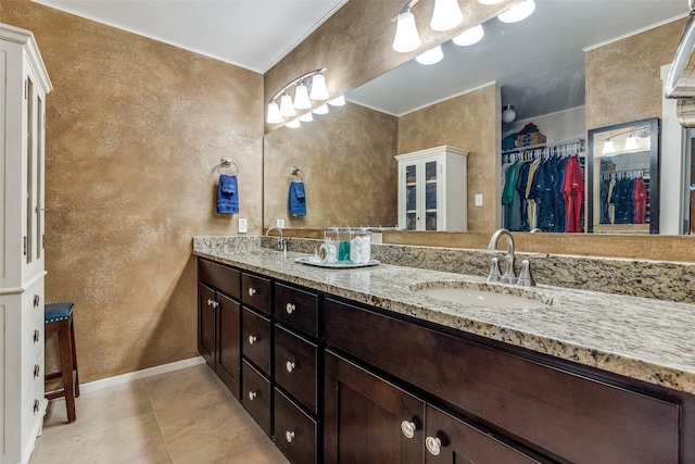 3150 Palmdale Cir, Farmers Branch, TX 75234 - full bath featuring a textured wall, double vanity, a spacious closet, and tile patterned floors