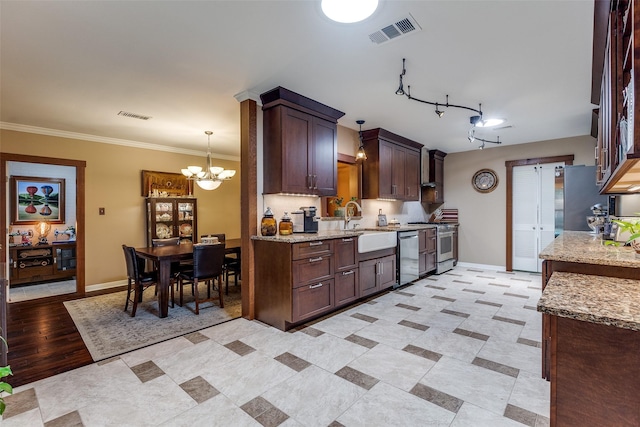3150 Palmdale Cir, Farmers Branch, TX 75234 - kitchen featuring a chandelier, a sink, stainless steel appliances, baseboards, and light stone counters