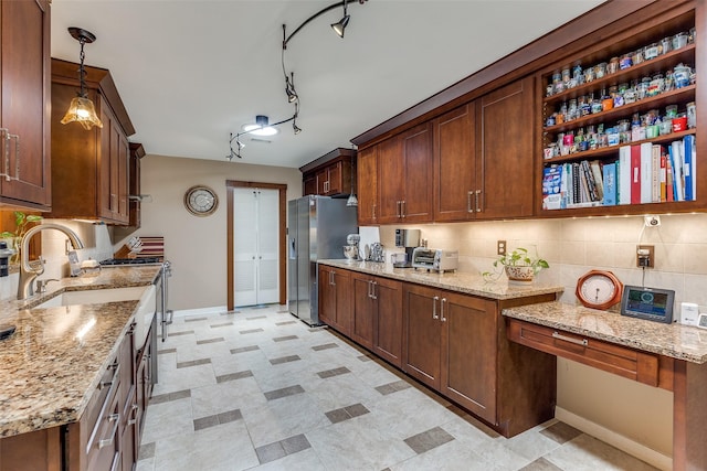 3150 Palmdale Cir, Farmers Branch, TX 75234 - kitchen with stainless steel fridge with ice dispenser, gas range oven, baseboards, and light stone countertops