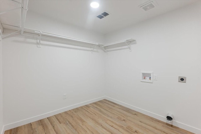 laundry area featuring hookup for an electric dryer, laundry area, visible vents, wood finished floors, and hookup for a washing machine
