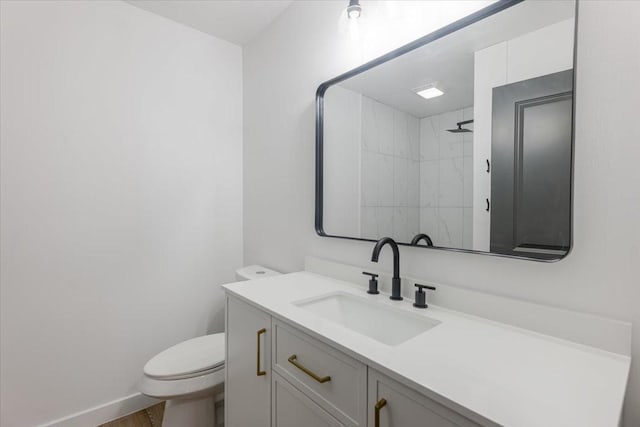 full bath featuring walk in shower, vanity, toilet, baseboards, and wood finished floors
