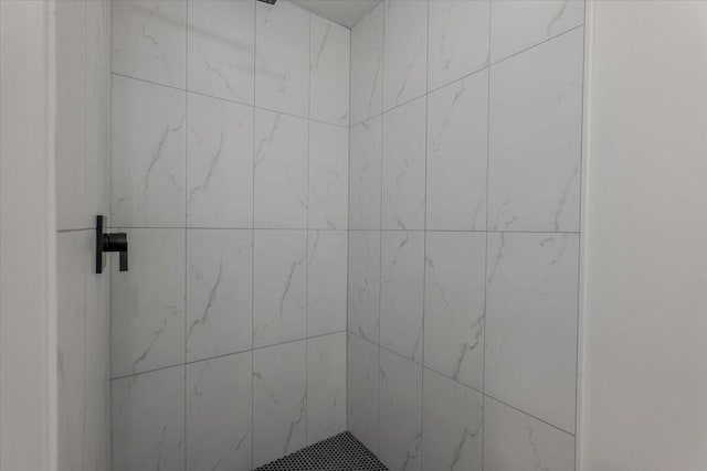 bathroom with tiled shower