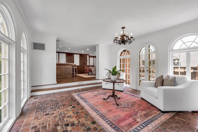 8 Westover Rd, Westover Hills, TX 76107 - living area featuring crown molding, brick floor, a notable chandelier, and visible vents