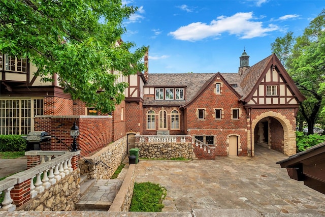 8 Westover Rd, Westover Hills, TX 76107 - tudor house featuring a patio and brick siding