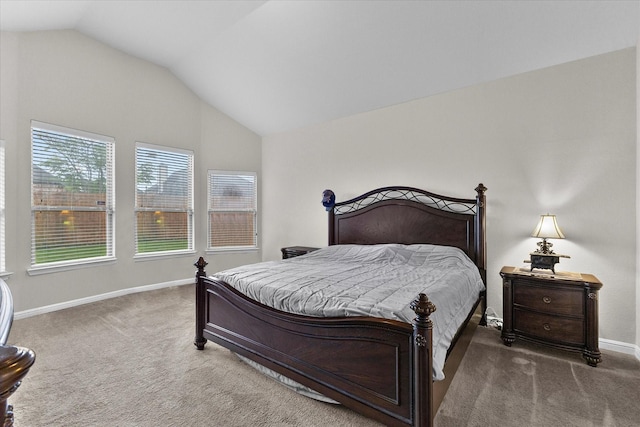 bedroom featuring baseboards, carpet flooring, and vaulted ceiling
