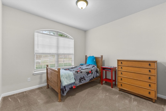 carpeted bedroom featuring baseboards