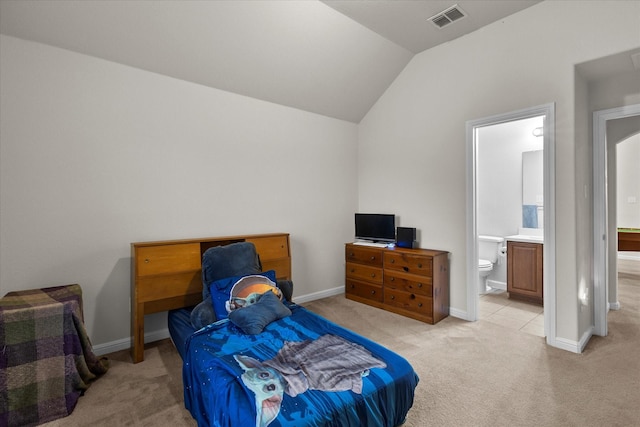 bedroom with visible vents, light carpet, baseboards, connected bathroom, and vaulted ceiling