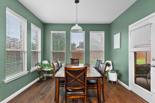 dining space featuring baseboards, dark wood finished floors, and a wealth of natural light