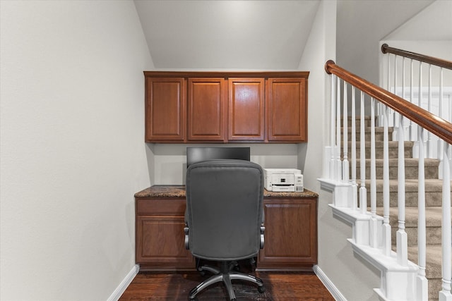 office featuring baseboards, dark wood-style floors, built in desk, and lofted ceiling