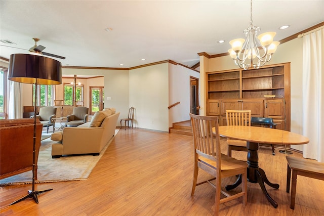 dining room featuring visible vents, light wood-type flooring, ceiling fan with notable chandelier, ornamental molding, and recessed lighting