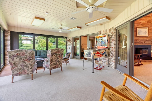 sunroom with ceiling fan, an outdoor hangout area, and visible vents