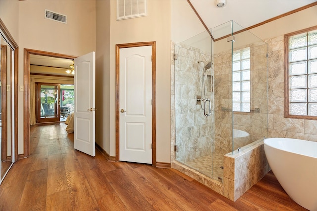 bathroom featuring a soaking tub, visible vents, and a wealth of natural light