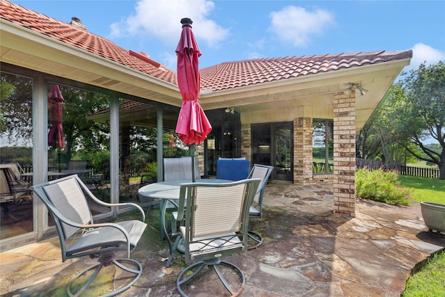 view of patio featuring fence and outdoor dining area