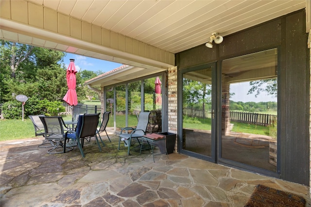 view of patio with fence and outdoor dining space