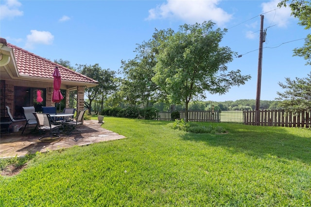 view of yard with fence and a patio area